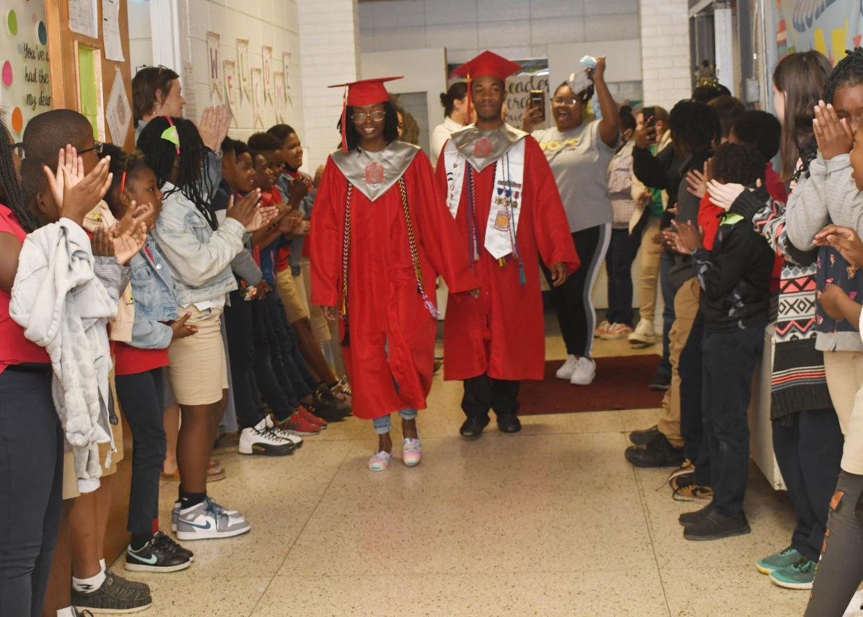 There were cheers, tears and the Pineville Elementary School Drumline following Pineville High School seniors Dontrell Allen and Geraldine Milo as they walked through the halls filled with students at PES Thursday.