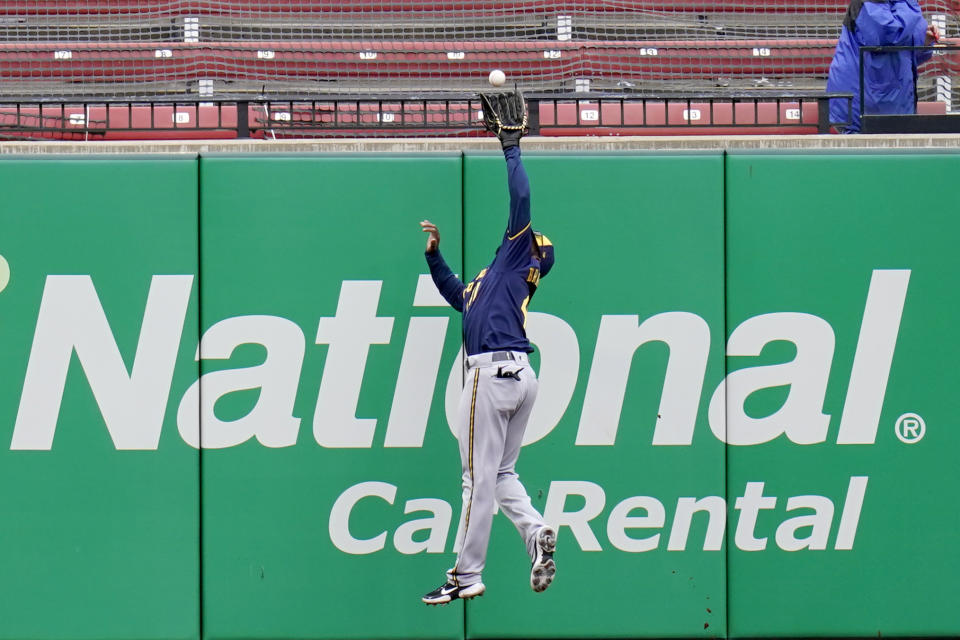 Milwaukee Brewers center fielder Jackie Bradley Jr. leaps to catch a fly ball by St. Louis Cardinals' Justin Williams for an out during the eighth inning of a baseball game Saturday, April 10, 2021, in St. Louis. (AP Photo/Jeff Roberson)