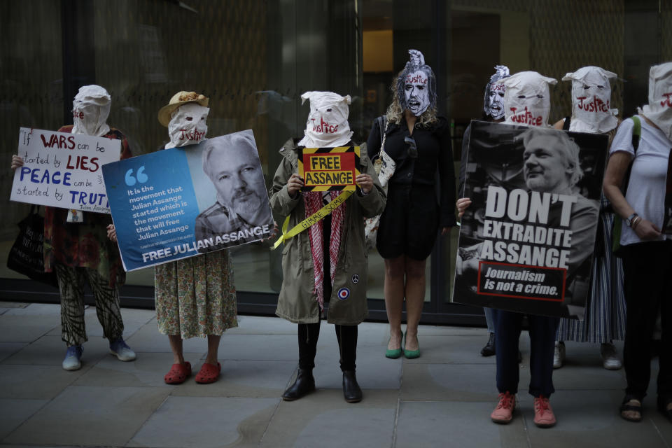 Supporters of WikiLeaks founder Julian Assange take part in a protest outside the Central Criminal Court, the Old Bailey, in London, Monday, Sept. 14, 2020. The London court hearing on Assange's extradition from Britain to the United States resumed Monday after a COVID-19 test on one of the participating lawyers came back negative, WikiLeaks said Friday. (AP Photo/Matt Dunham)