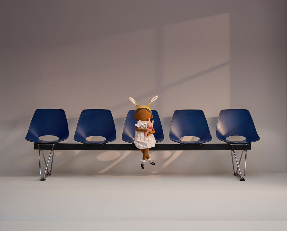 Amelia's doll sitting on some chairs