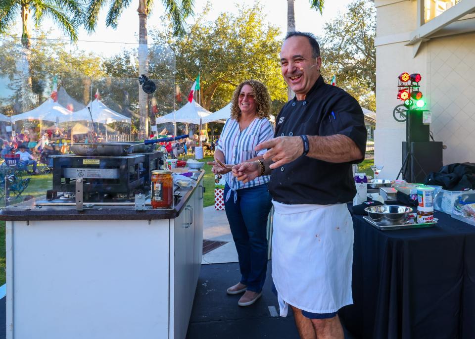 Chef Marco Sciortino invites Lourdes Marzigliano from the audience to help him make gnocchi during the Feast of Little Italy 20th Anniversary street festival at Abacoa Town Center in Jupiter.