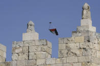 A Palestinian flag attached to a drone flies over the ramparts of the Damascus Gate of the Old City of Jerusalem as Israelis mark Jerusalem Day, an Israeli holiday celebrating the capture of the Old City during the 1967 Mideast war, Sunday, May 29, 2022. In recent weeks, Israeli authorities have gone out of their way to challenge the hoisting of the Palestinian flag. Palestinian citizens of Israel see the campaign against the flag as another affront to their national identity and their rights as a minority in the majority Jewish state. (AP Photo/Mahmoud Illean, File)
