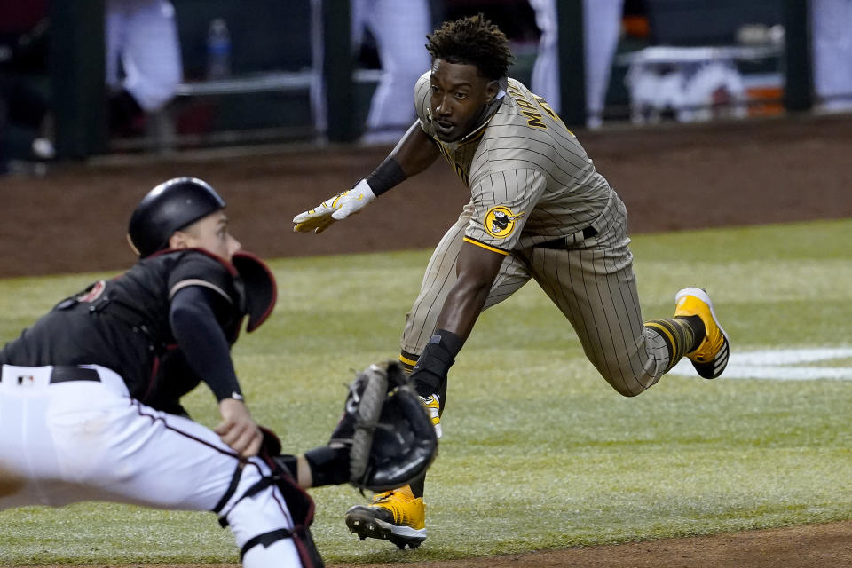 San Diego Padres' Jorge Mateo tries to score as Arizona Diamondbacks catcher Carson Kelly waits for the throw during the ninth inning of a baseball game Saturday, Aug. 15, 2020, in Phoenix. Mateo was out on the play for the final out of the game. The Diamondbacks won 7-6. (AP Photo/Matt York)