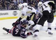 Columbus Blue Jackets' Sergei Bobrovsky, right center, of Russia, protects the goal as teammate David Savard, front left, Pittsburgh Penguins' James Neal, top left, and Evgeni Malkin, right, also of Russia, fight for a loose puck during the first period of Game 4 of a first-round NHL hockey playoff series on Wednesday, April 23, 2014, in Columbus, Ohio. (AP Photo/Jay LaPrete)