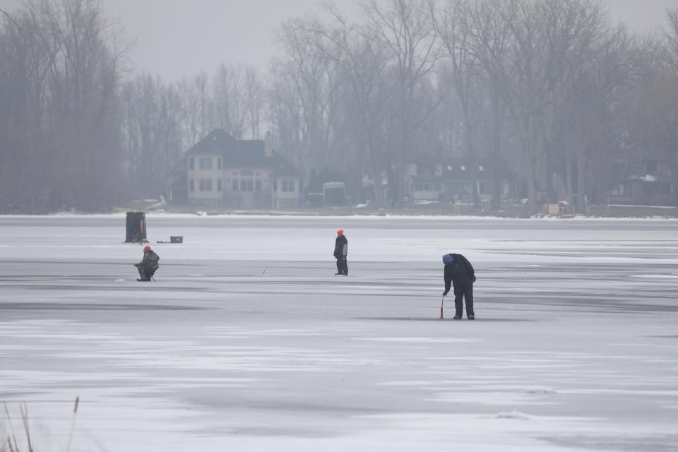 Ice fisherman watch their lines on Long Pond in Greece on Thursday.