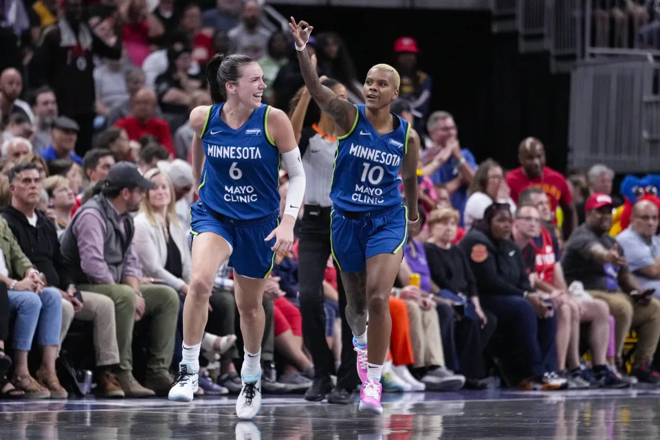 Minnesota Lynx guard Courtney Williams (10) and forward Bridget Carleton (6) celebrate after William hits a three-point basket against the Indiana Fever in the second half of a WNBA basketball game in Indianapolis, Friday, Sept. 6, 2024. (AP Photo/Michael Conroy)