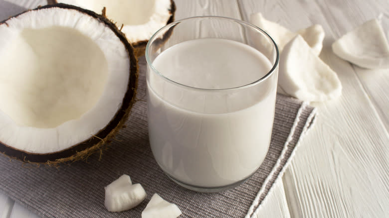 coconut milk beside halved coconut