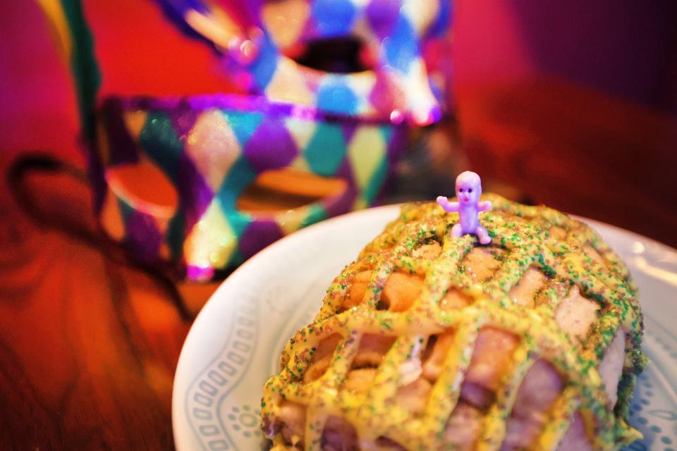 A baby rests on top of a King Cake made at Memphis Whistle in Cooper Young on Tuesday, Jan. 18, 2022. 