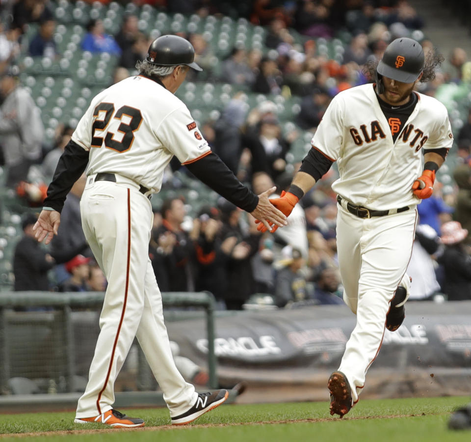 San Francisco Giants' Brandon Crawford, right, is congratulated by third base coach Ron Wotus (23) after hitting a home run in the sixth inning of a baseball game against the Toronto Blue Jays Wednesday, May 15, 2019, in San Francisco. (AP Photo/Ben Margot)