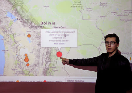 Seismologist Gonzalo Fernandez shows on a map the epicenter of an earthquake registered in the south of Bolivia, in La Paz, Bolivia, April 2, 2018. REUTERS/David Mercado