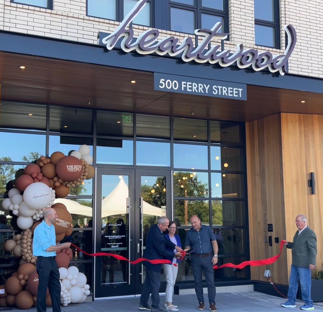 Jim Atkins, co-owner of Atkins Dame, LLC., Mayor Lucy Vinis and Denny Braud, director of the city of Eugene’s Planning and Development department, cut the ribbon for the opening of the Heartwood on June 13. The Heartwood is the River District's first residential building.