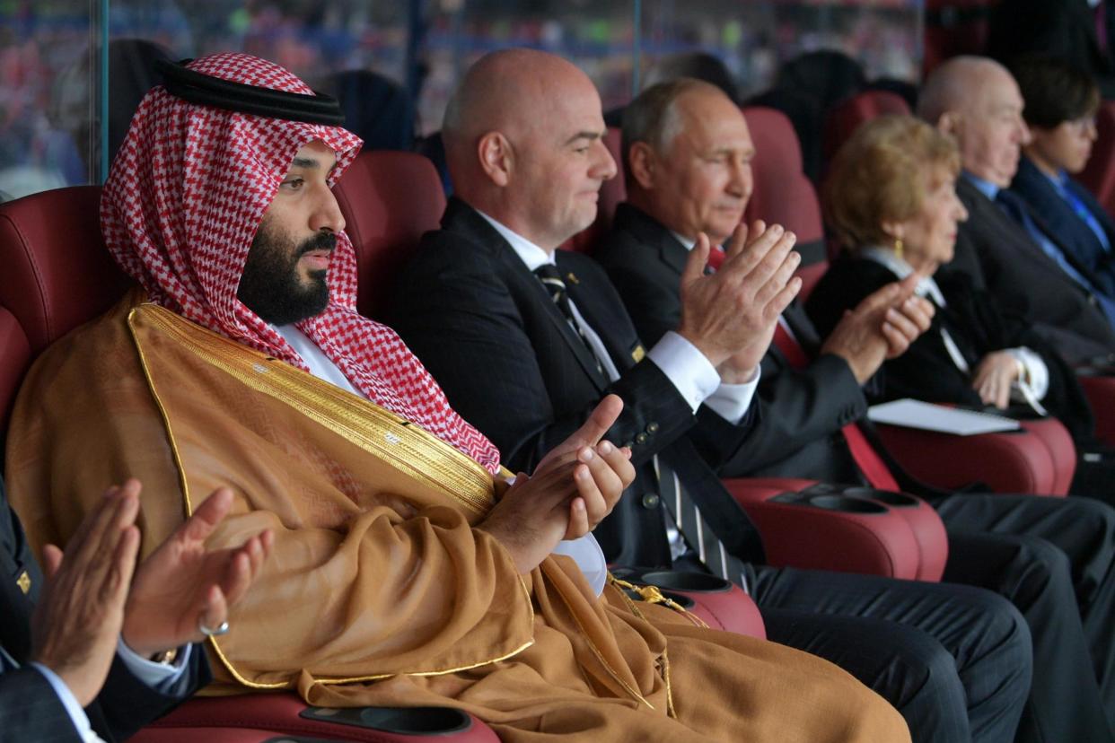 Mohammed bin Salman, Fifa president Gianni Infantino and Vladimir Putin watch the 2018 World Cup match between Russia and Saudi Arabia (AFP/Getty)