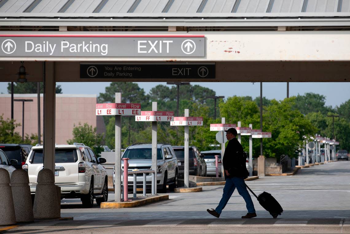 A traveler walks through a parking area at Raleigh-Durham International Airport on Monday, May 22, 2023.