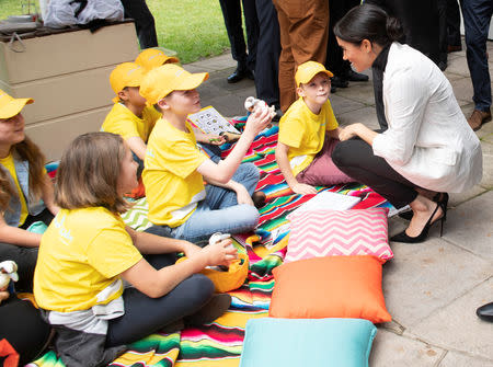 BritainÕs Prince Harry and Meghan, the Duchess of Sussex chat with schoolchildren while attending a lunchtime Reception hosted by the Prime Minister with Invictus Games competitors, their family and friends in the cityÕs central parkland Sydney October 21, 2018. Paul Edwards /Pool via REUTERS