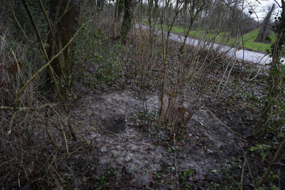Holes dug by treasure hunters looking for a Nazi loot are seen in Ommeren, near Arnhem, Netherlands, Thursday, Jan. 19, 2023. A hand-drawn map with a red letter X purportedly showing the location of a buried stash of precious jewelry looted by Nazis from a blown-up bank vault has sparked a modern-day treasure hunt in a tiny Dutch village. (AP Photo/Peter Dejong)