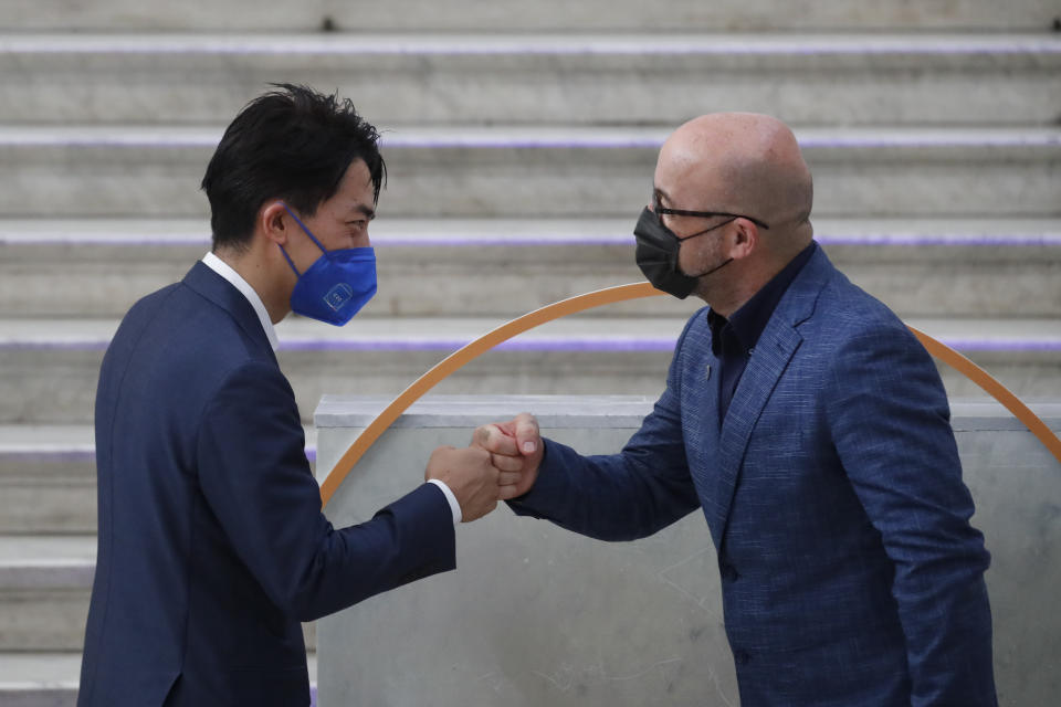 Japan's Environment Minister Shinjirō Koizumi is welcomed by Italian Minister for Ecological Transition Roberto Cingolani as he arrives at Palazzo Reale in Naples, Italy, Thursday, July 22, 2021, to take part in a G20 meeting on environment, climate and energy. (AP Photo/Salvatore Laporta)