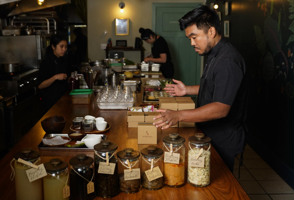 Chef Aaron Verzosa of Filipino American restaurant Archipelago, who is nominated for a 2023 James Beard Award, boxes brown butter masa mamon, Wednesday, May 24, 2023, in Seattle. Verzosa is nominated in the Best Chef: Northwest and Pacific category. (AP Photo/Lindsey Wasson)