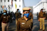 Police officer stands guard out of a venue where farmer leaders meet with government representatives in New Delhi