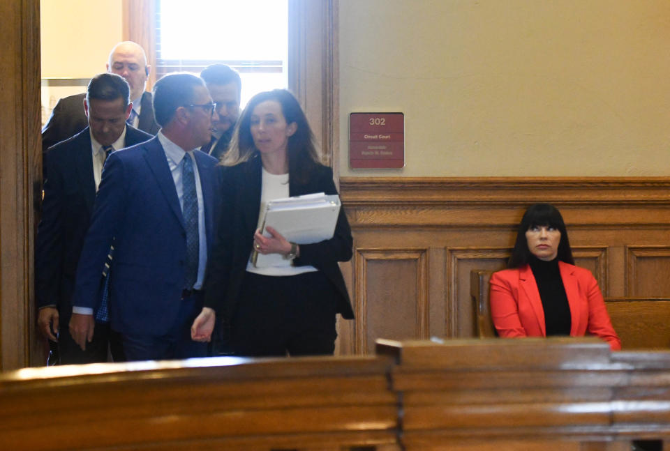 Brenda Tracy glances up as members of both she and former MSU football Coach Mel Tucker's legal teams exit the judge's chambers, Thursday, Oct. 26, 2023, before a hearing at Ingham County Circuit Court.