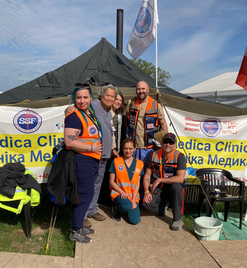 Columbus physican Ean Bett, standing far right, at a makeshift medical tent on the Poland-Ukraine border, where he recently volunteered  with a medical and humanitarian group providing care to Ukrainians who were fleeing their war-torn homeland.