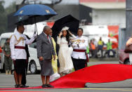 Meghan, Duchess of Sussex waits with Fiji Prime Minister Frank Bainimarama, left, as a red carpet is laid during a welcome ceremony in Suva, Fiji, Tuesday, Oct. 23, 2018. Britain's Prince Harry and his wife Meghan are on day eight of their 16-day tour of Australia and the South Pacific. Kirsty Wigglesworth/Pool via REUTERS