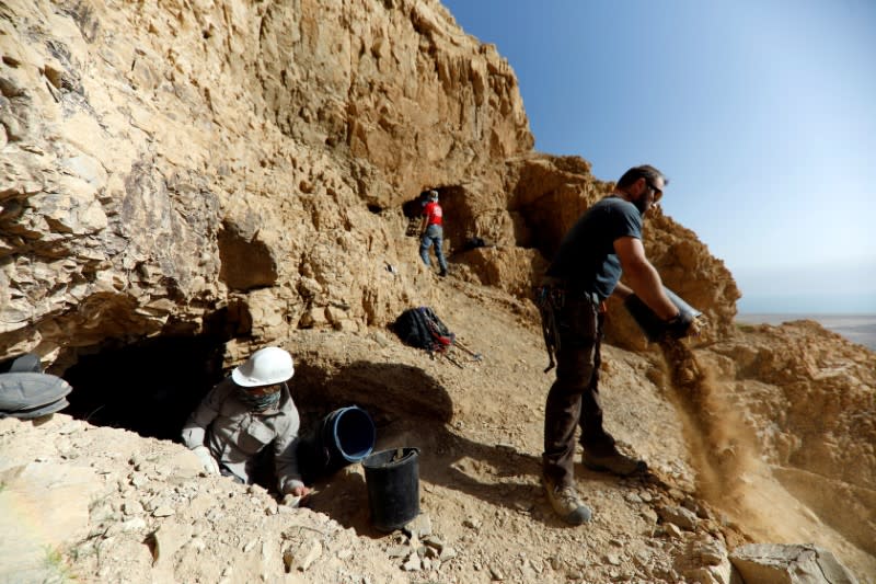 FILE PHOTO: Volunteers and archaeologists work at dig near caves in the Qumran area