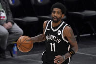 FILE - Brooklyn Nets guard Kyrie Irving handles the ball during an NBA basketball game against the Dallas Mavericks in Dallas, in this Thursday, May 6, 2021, file photo. Unable to attend the Brooklyn Nets' media day, Kyrie Irving asked for privacy Monday when pressed about his vaccination status and availability for home games. (AP Photo/Tony Gutierrez)