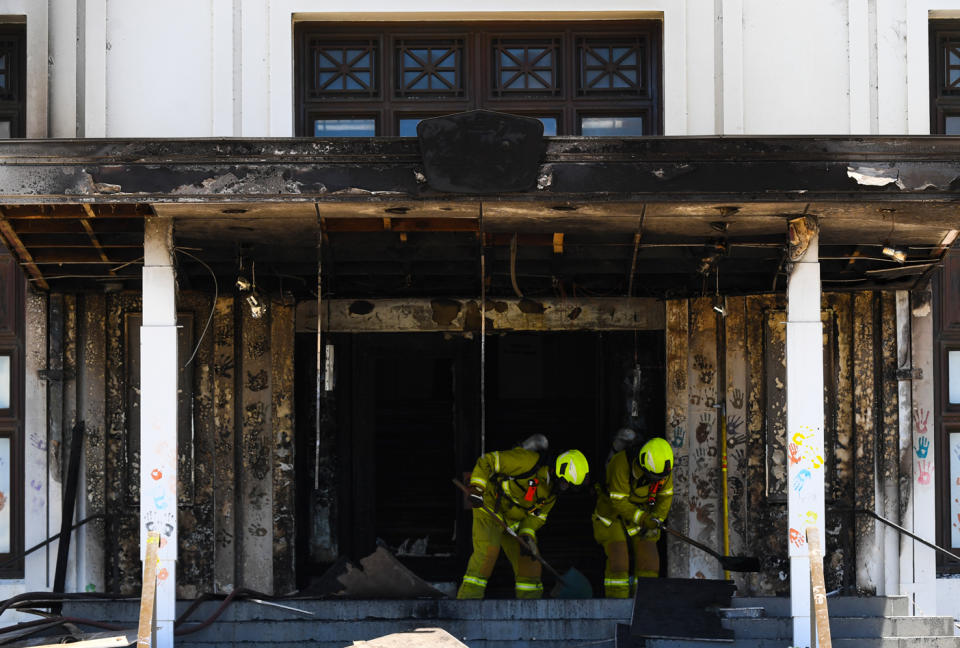 Firefighters are seen entering the fire damaged entrance to Old Parliament House in Canberra on December 30, 2021.