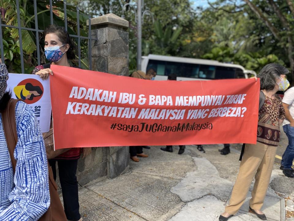 Two women hold up a banner questioning if Malaysian mothers have different citizenship status from Malaysian fathers. — Picture courtesy of Family Frontiers