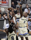 San Antonio Spurs guard DeMar DeRozan, center, drives to the basket against Milwaukee Bucks guard Wesley Matthews (9) during the second half of an NBA basketball game in San Antonio, Monday, Jan. 6, 2020. (AP Photo/Eric Gay)