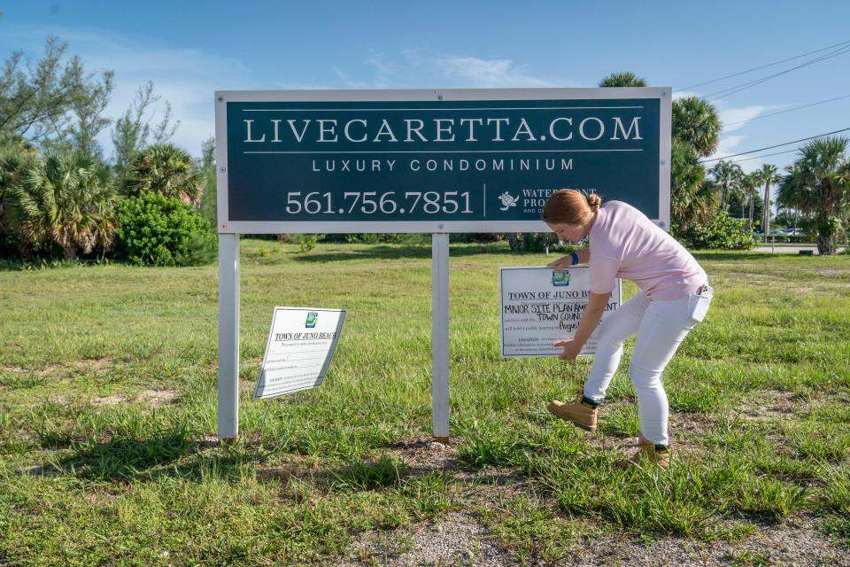 Town planning tech Isabella Hickey posts a public hearing notice in the ground at the future site of the Caretta luxury condominiums on the northwest corner of Donald Ross Road and U.S. 1 in Juno Beach, Florida on 2023.