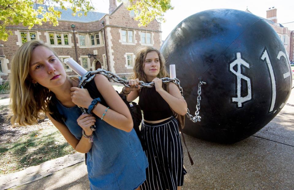 Students pull a mock "ball & chain" representing the $1.4 trilling outstanding student debt at Washington University in St. Louis, Missouri, in 2016. (Photo: PAUL J. RICHARDS/AFP/Getty Images) 