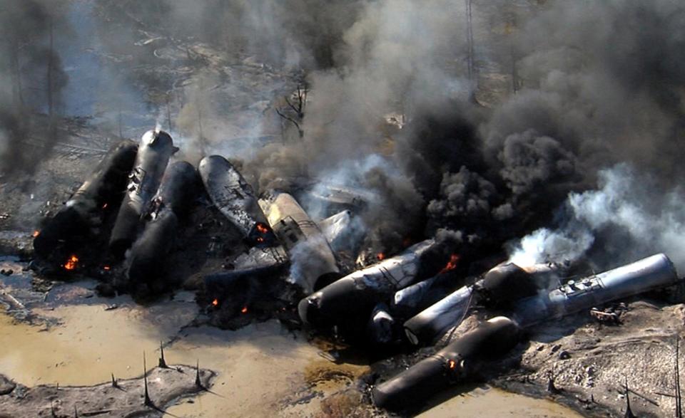 Smoke rises from a number of cars that derailed and exploded from a train carrying crude oil in Aliceville