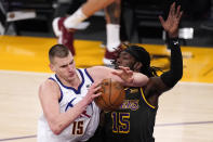 Denver Nuggets center Nikola Jokic, left, elbows past Los Angeles Lakers center Montrezl Harrell during the first half of an NBA basketball game Monday, May 3, 2021, in Los Angeles. (AP Photo/Mark J. Terrill)