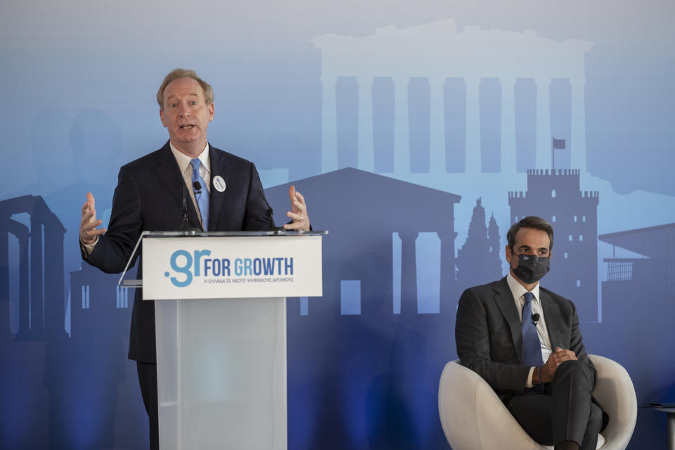 Microsoft President Brad Smith, left, speaks next to Greek Prime Minister Kyriakos Mitsotakis during a ceremony held in the Acropolis Museum, central Athens, on Monday, Oct. 5, 2020. Microsoft has announced plans to build three data centers in greater Athens, providing a badly needed investment of up to $1 billion to the Greek economy which has been hammered by the pandemic. (AP Photo/Petros Giannakouris)