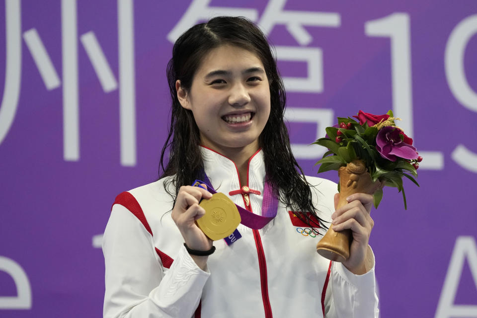 Gold medalist China's Zhang Yufei celebrates during the medal ceremony for the women's 200 meter butterfly swimming at the 19th Asian Games in Hangzhou, China, Sunday, Sept. 24, 2023. (AP Photo/Lee Jin-man)