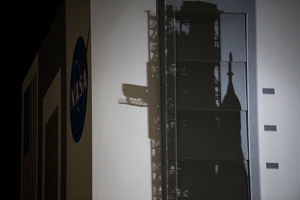 In this handout image provided by NASA, NASA's Space Launch System (SLS) rocket with the Orion spacecraft aboard atop the mobile launcher is seen on the Vehicle Assembly Building at Kennedy Space Center on August 16, 2022, in Cape Canaveral, Florida.