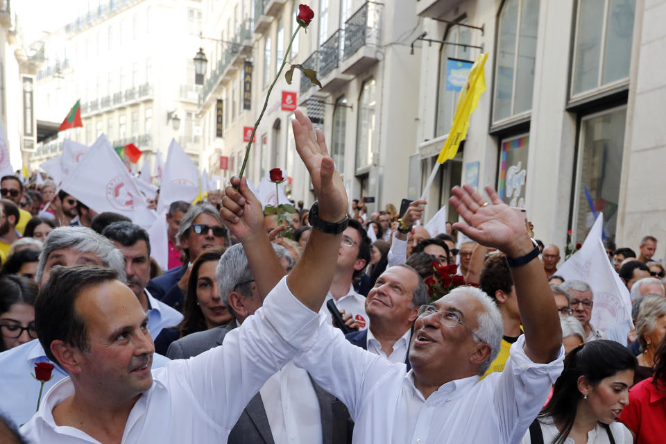 Portuguese Prime Minister and Socialist Party leader Antonio Costa, right, and Lisbon Socialist Mayor Fernando Medina, left, wave to supporters during an election campaign action in downtown Lisbon Friday, Oct. 4, 2019. Portugal will hold a general election on Oct. 6 in which voters will choose members of the next Portuguese parliament. The ruling Socialist Party hopes an economic recovery during its four years of governing will persuade voters to return the party to power. (AP Photo/Armando Franca)