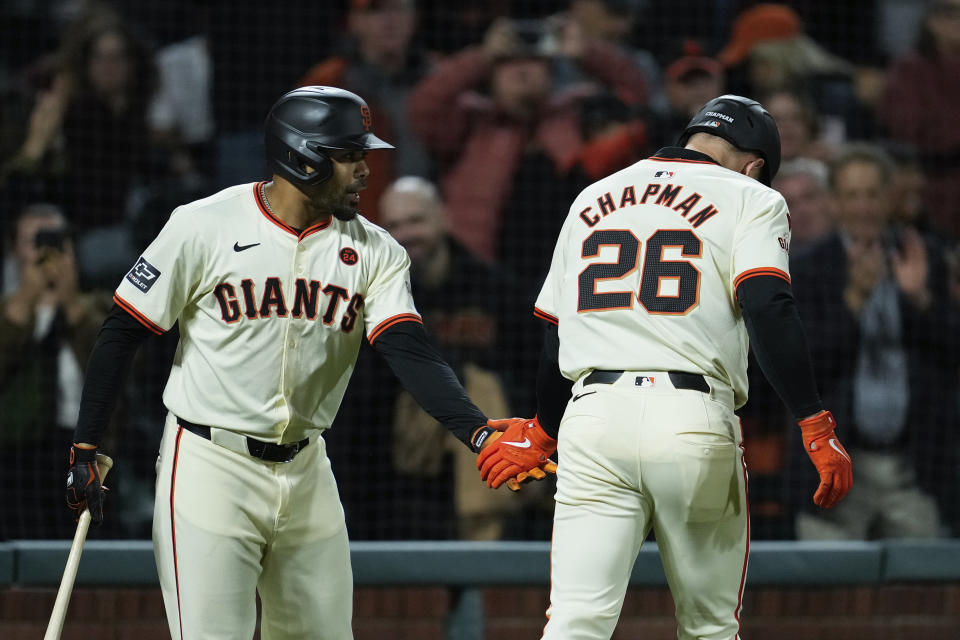 San Francisco Giants' Matt Chapman, right, is congratulated by LaMonte Wade Jr., left, after hitting a solo home run during the fourth inning of a baseball game against the Milwaukee Brewers, Wednesday, Sept. 11, 2024, in San Francisco. (AP Photo/Godofredo A. Vásquez)