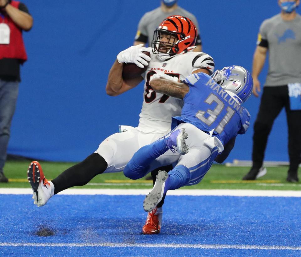 Cincinnati Bengals tight end C.J. Uzomah (87) catches a touchdown pass against Detroit Lions safety Dean Marlowe (31) during the second half Sunday, Oct. 17, 2021 at Ford Field.