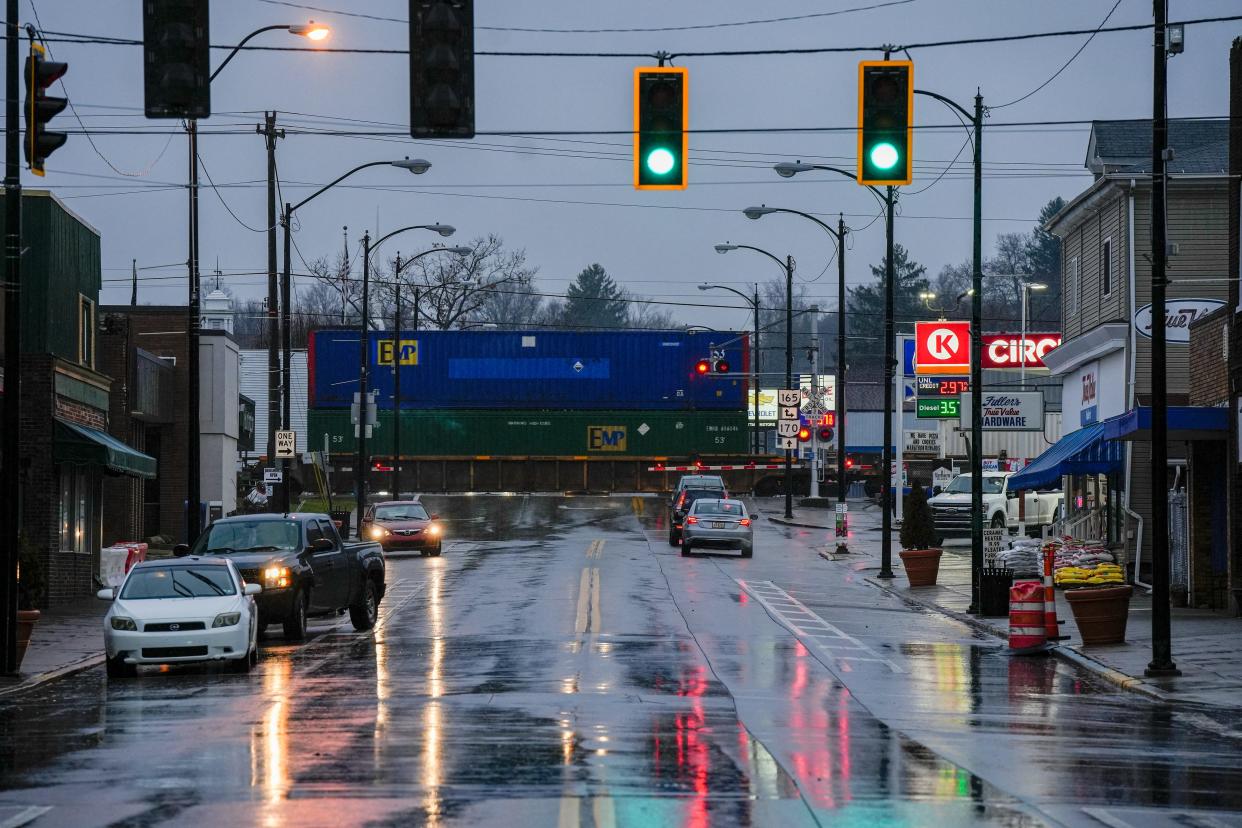 A Norfolk Southern train passes Market Street in downtown East Palestine on Wednesday, January 24, 2024, almost a year after a train derailed near Market Street when a mechanical issue with a rail car axle caused a fiery accident. Fifty cars derailed and 11 were carrying hazardous materials.