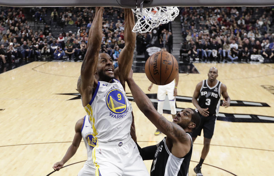 Golden State Warriors guard Andre Iguodala (9) scores over San Antonio Spurs forward LaMarcus Aldridge (12) during the first half of an NBA basketball game Sunday, Nov. 18, 2018, in San Antonio. (AP Photo/Eric Gay)