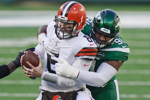 New York Jets defensive end John Franklin-Myers (91) sacks Cleveland Browns quarterback Baker Mayfield (6) during the first half of an NFL football game Sunday, Dec. 27, 2020, in East Rutherford, N.J. (AP Photo/Corey Sipkin)