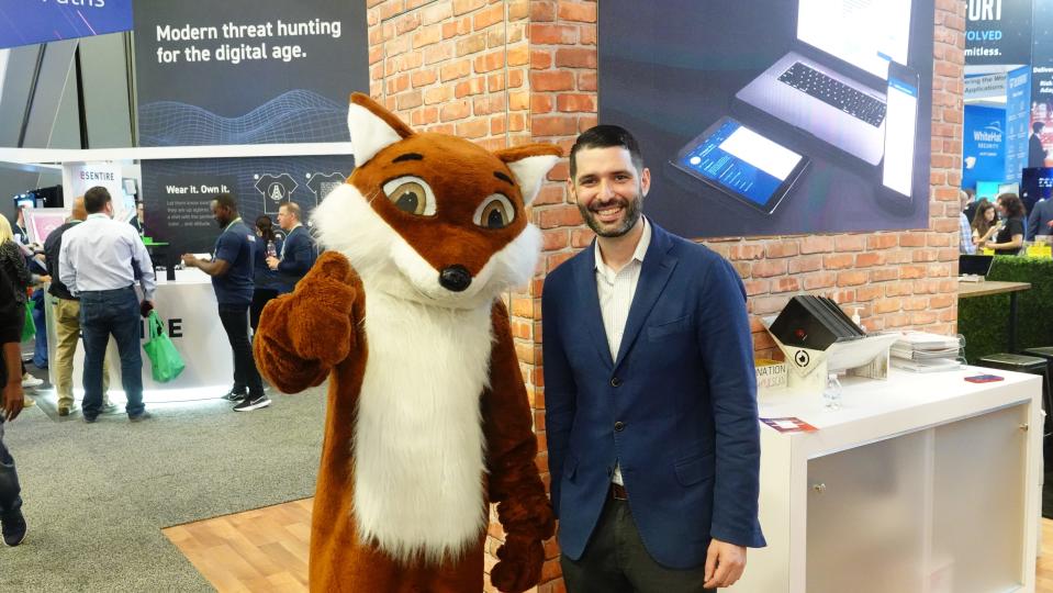 Sam Small, the chief security officer for ZeroFOX, a digital security firm, poses with a fox mascot at the RSA Conference in San Francisco