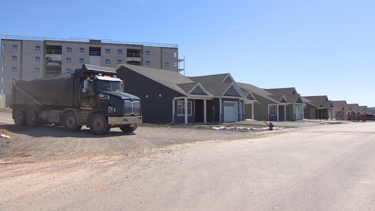 A dumptruck leaves a construction site where an apartment building and new housing are going up in Windsor, N.S. A development boom has led to the need for increased capacity in the municipality's water system. (CBC - image credit)