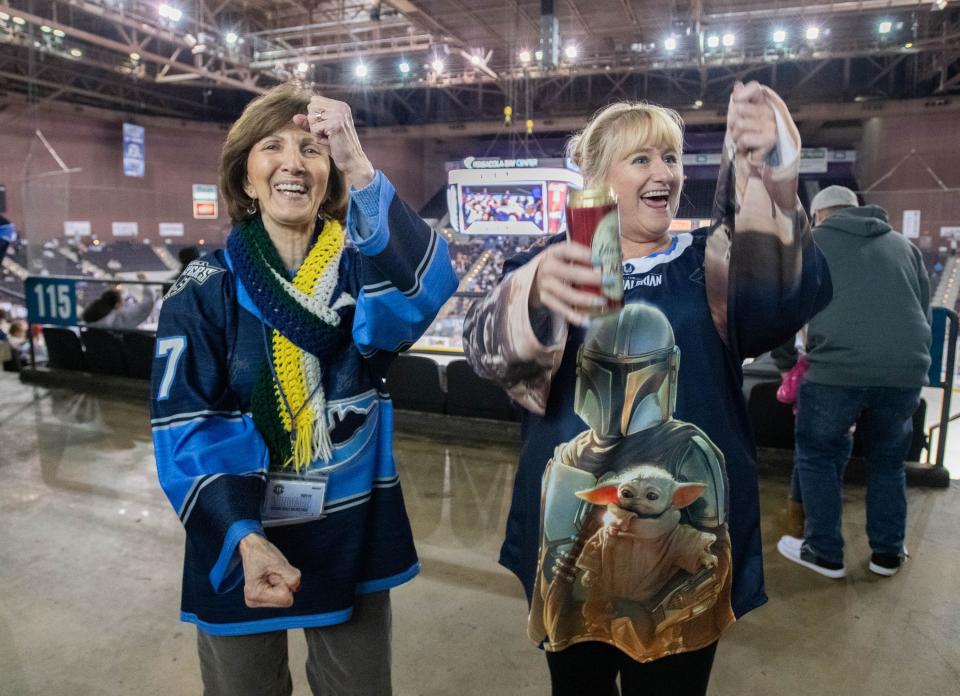 Longtime Ice Flyers fans Tammy Wehmeier, left, and Anne Smerekanicz demonstrate the goal scoring celebration dance during the Peoria Rivermen vs Pensacola Ice Flyers ice hockey game in Pensacola on Thursday, Jan. 4, 2024.