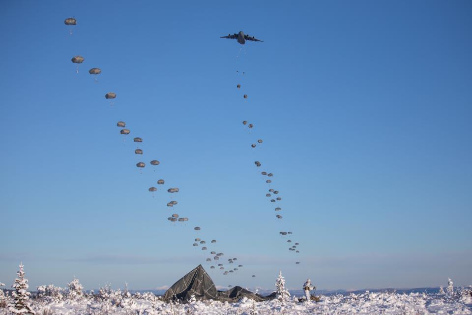 U.S. Army paratroopers assigned to 3rd Battalion, 509th Parachute Infantry Regiment, 2nd Infantry Brigade Combat Team (Airborne), 11th Airborne Division, descend from C-17 Globemaster IIIs onto Donnelly Drop Zone during an airborne operation as part of Joint Pacific Multinational Readiness Center 24-02 at Donnelly Training Area, Alaska, Feb. 8, 2024.