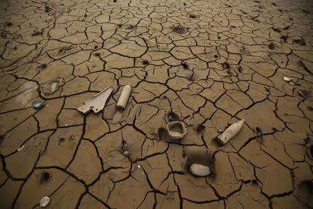 Bottles and containers lie in mud after rivers breached their banks due to torrential rains, causing flooding and widespread destruction in Carapongo Huachipa, Lima, Peru, March 21, 2017. REUTERS/Mariana Bazo