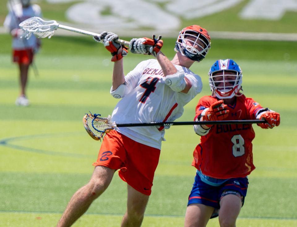 The Benjamin Buccaneers Sean Sheehan (4) shoots for a goal while defended by Bolles Bulldogs Cam Zielinski (8) in a State Lacrosse Semifinal matchup on Thursday May, 9, 2024 at the Paradise Coast Sports Complex in Naples. Photo By Chris Tilley