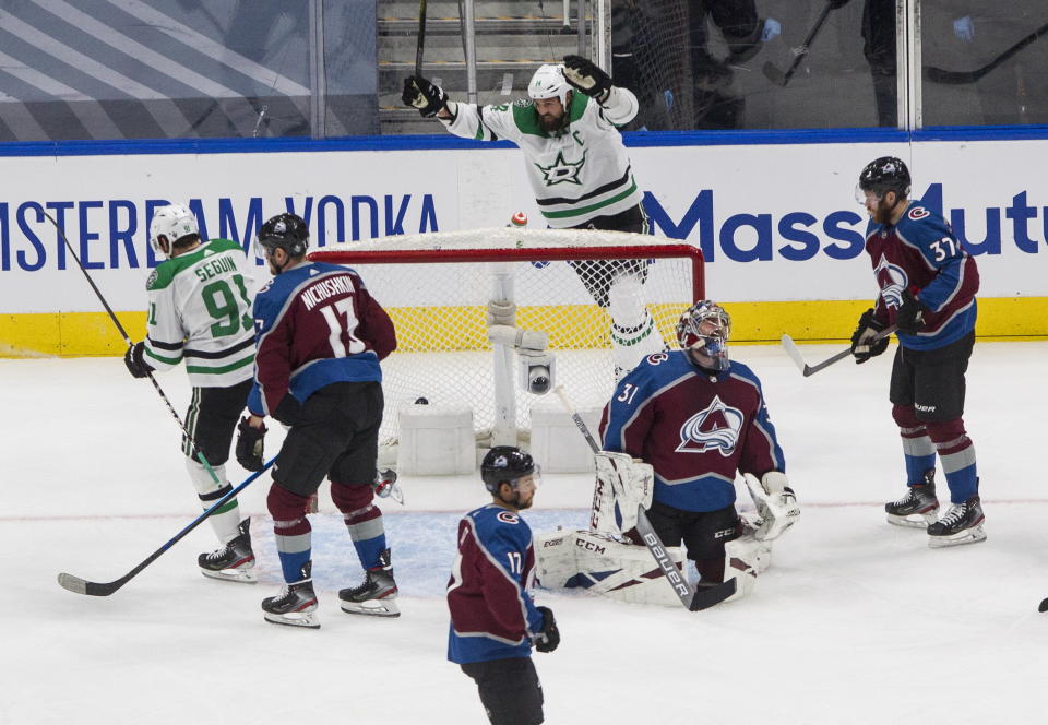 Colorado Avalanche goalie Philipp Grubauer (31) is scored against as Dallas Stars' Tyler Seguin (91) and Jamie Benn (14) celebrate during first-period NHL Western Conference Stanley Cup playoff hockey game action in Edmonton, Alberta, Saturday, Aug. 22, 2020. (Jason Franson/The Canadian Press via AP)